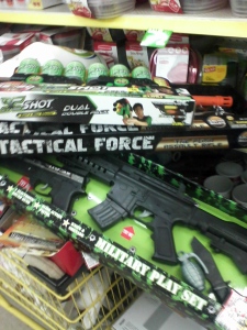 Toy guns in a dollar store, next to unrelated items